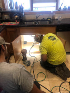 Worker Fixing Clogged Pipe