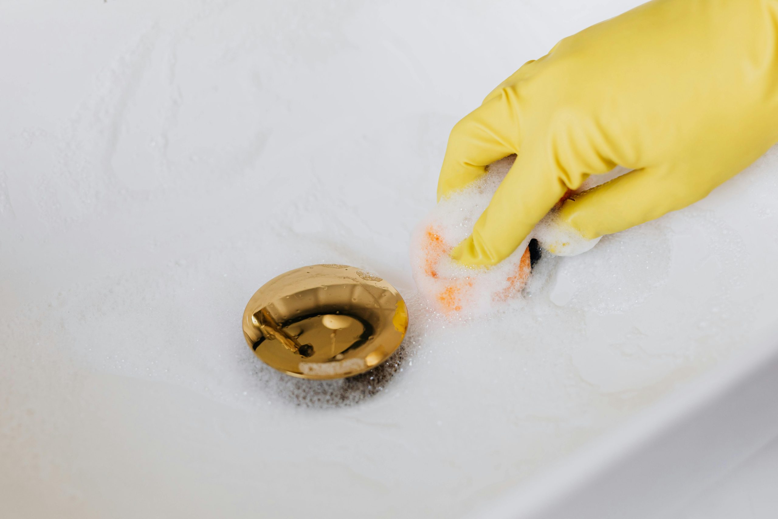 A woman handling drain cleaning in a home in Chicago