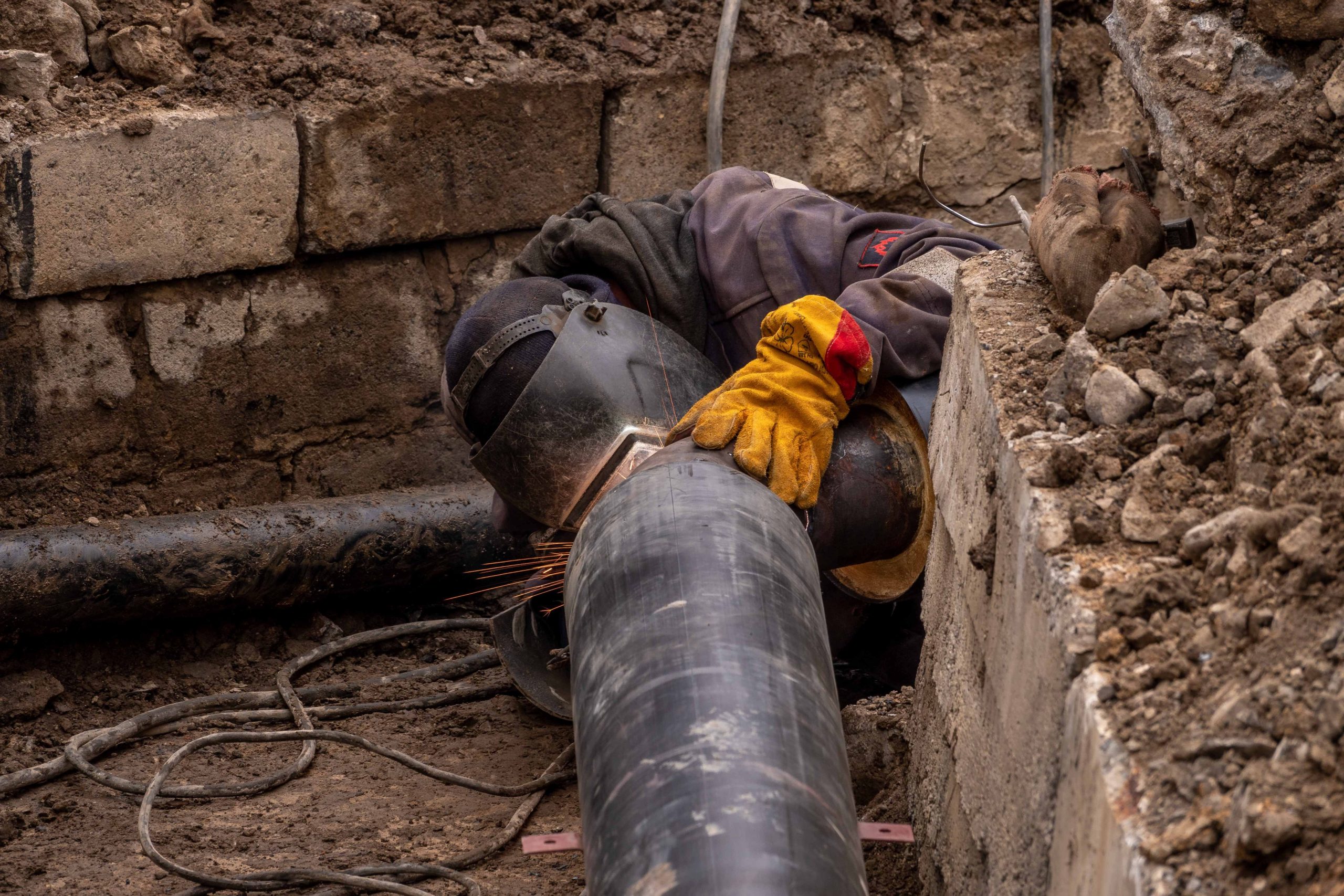 A sewer line repair professional welding a pipe in Chicago