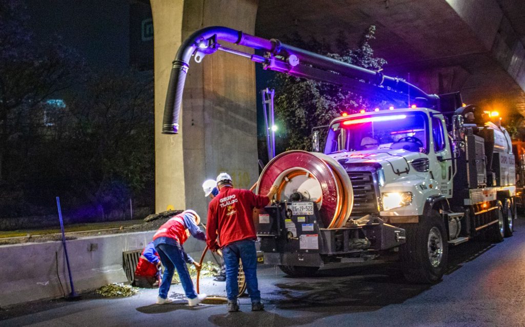 A sewer line repair crew inspecting a sewer line in Chicago